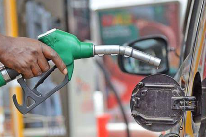 Fuel station attendant in Ogun displaying fuel price in Western Nigeria today on pump