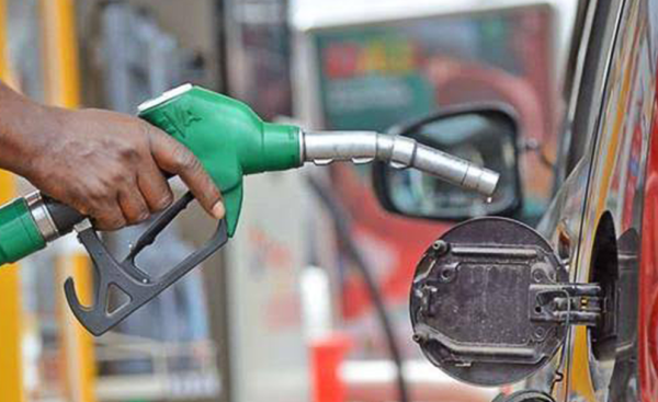 Fuel station attendant in Ogun displaying fuel price in Western Nigeria today on pump